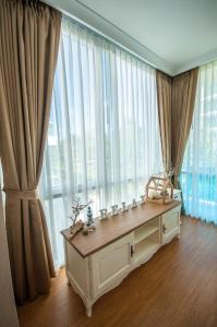a room with a large window with curtains at My Resort Family Condo in Hua Hin