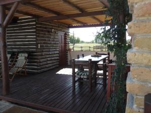 a wooden deck with a table and chairs on it at Walter Ranch in Kaskantyú