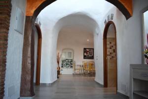 a hallway with white walls and arches in a house at Casas Cueva con piscina y barbacoa in Fontanar +91 photos