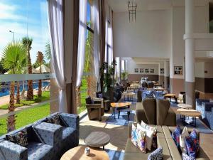 a hotel lobby with couches and tables and windows at Wazo Hotel in Marrakesh