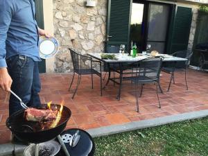 a man is cooking a turkey on a grill at Villa Bikini on Sorrento Coast in Vico Equense