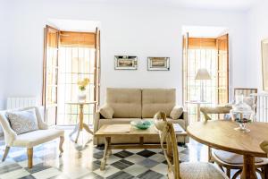 a living room with a couch and a table and chairs at Apartamento Garcia Lorca II in Granada