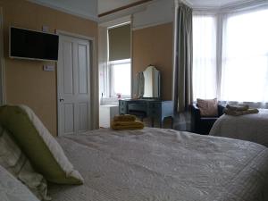 a hotel room with a bed and a television at Albert Hotel in Peterhead