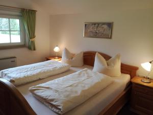 a bedroom with two beds with white pillows at Lizzi Mountain Apartments in Schwangau