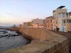 a group of buildings on a street next to the water at Casa Nova b&b in Alghero