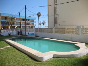una piscina en el césped junto a un edificio en Apartamentos Olimpo 3000, en Peñíscola