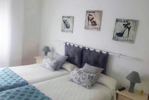 a bedroom with two beds and two pictures on the wall at Las Cadenas in Ledesma