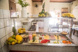 a kitchen with a bunch of food on a counter at Adry Hotel Inn Itajaí Navegantes in Itajaí