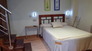 A bed or beds in a room at Apartamentos Santana