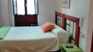 A bed or beds in a room at Apartamentos Santana