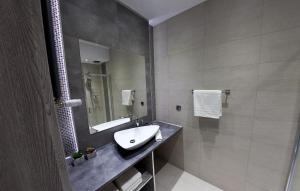a bathroom with a sink and a mirror at Euro Apartments Piwna in Gdańsk