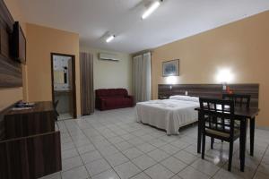 Habitación de hotel con cama y sofá en Augustu's Hotel, en Altamira