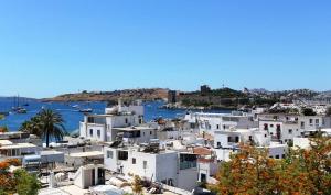 a view of a town with white houses and the water at Agan Pension in Bodrum City