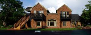 a brick house with two balconies and a staircase at Hillwinds Inn - Blowing Rock in Blowing Rock