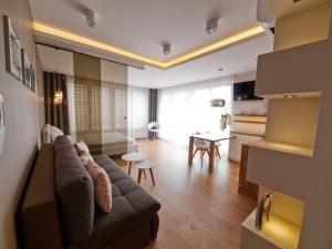 a living room with a couch and a table at Apartament Aria Studio in Kraków