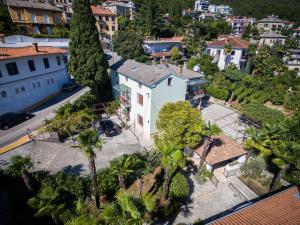 an aerial view of a white house with palm trees at Apartments Kinkela in Opatija