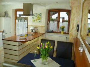 a kitchen with a table with a vase of flowers at Villa Casa in Bad Tölz