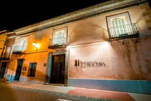 a building with a sign on the side of it at Hacienda la Coracera in San Martín de Valdeiglesias