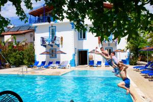 a group of kids playing in the pool at a resort at Dove Apart Hotel in Fethiye