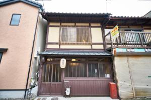 a building with two garage doors in front of it at Mibuan in Kyoto