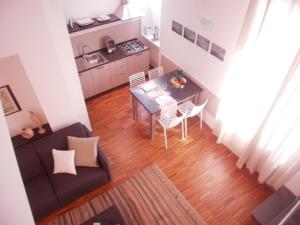 a living room with a couch and a table and chairs at Appartamento Colombo in Chiavari