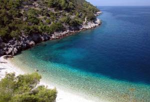 an aerial view of a beach with blue water at Captain's Attic in Račišće