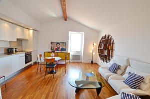 a living room with a couch and a table at Villefranche Sur Mer One Bed in Villefranche-sur-Mer