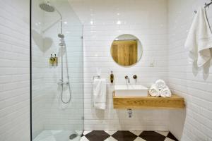 a bathroom with a sink and a shower at The House in Old Mint Street in Valletta