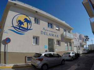 a building with a sign on the side of it at Apartamentos Delamar in Carboneras