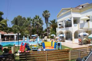 a resort with a pool with colorful slides at Alessandro in Sidari