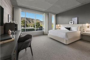 a hotel room with a large bed and a large window at Mountain Shadows Resort Scottsdale in Scottsdale