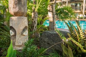 a stone statue of a face in a garden at Humphreys Half Moon Inn in San Diego