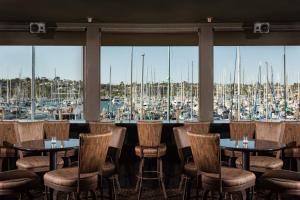 a restaurant with tables and chairs and a marina at Humphreys Half Moon Inn in San Diego
