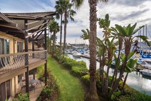 a balcony with palm trees and a marina at Humphreys Half Moon Inn in San Diego