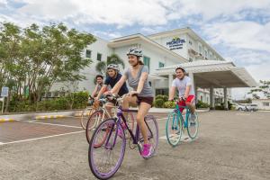 a group of people riding bikes in a parking lot at Microtel by Wyndham South Forbes near Nuvali in Santa Rosa