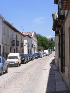 
a city street filled with cars and parked cars at Chinchonspa in Chinchón

