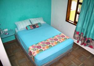 Postel nebo postele na pokoji v ubytování Yaxche Centro Hostal y Camping