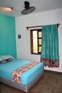 Postel nebo postele na pokoji v ubytování Yaxche Centro Hostal y Camping