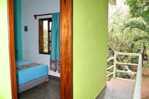 Postel nebo postele na pokoji v ubytování Yaxche Centro Hostal y Camping