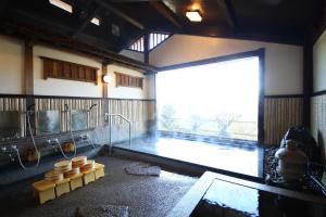 a room with a large window in a room with a pool at Iwamura Sanso -Castle Ryokan- in Ena +32 photos