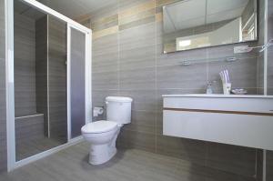 a bathroom with a toilet and a sink and a shower at Magnni Villa in Nanzhuang