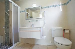 a bathroom with a toilet and a sink and a mirror at Magnni Villa in Nanzhuang