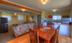 a living room with a table and a couch at Sommers Bay Beach House in Murdunna