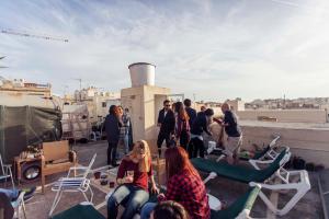 a group of people on the roof of a building at Granny's Inn Hostel in Sliema