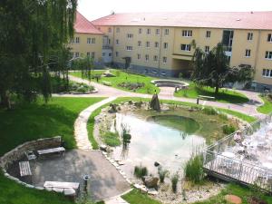 a view of a park with a fountain and a building at Gästehaus der LK-Technik Mold in Mold
