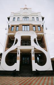 a tall building with the letters f on it at Hotel Schuka in Astrakhan