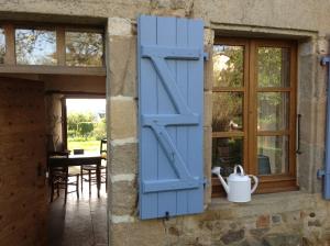 a blue door on the side of a house at Domaine Charente - Cottage Charente in Mazières