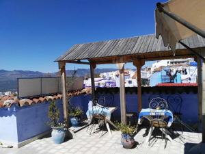 a patio with chairs and a gazebo at Hotel Ouarzazate in Chefchaouen