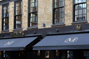 a building with a maumes sign on the front of it at Mimi's Hotel Soho in London