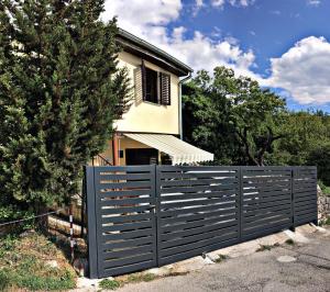 a fence in front of a house at Holiday home Barci in Crikvenica